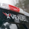 Raised vinyl dome Vexus decal applied to a vehicle near tail light, angled view